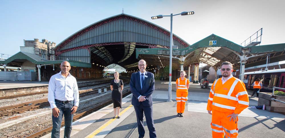 People stood on train platform outside Bristol Temple Meads railway station.