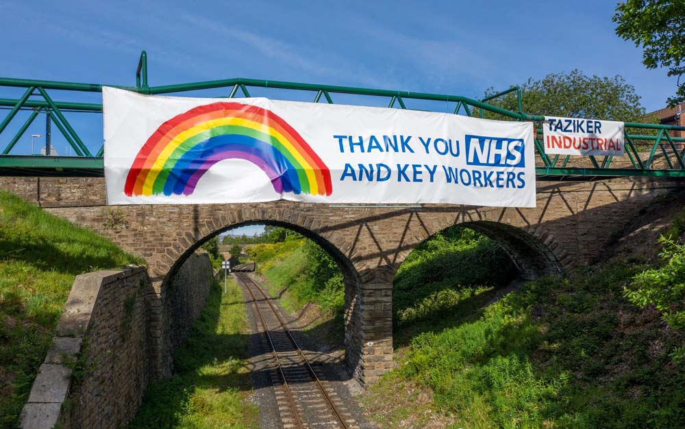"Thank you NHS and key workers" sign over Schofield Street footbridge.