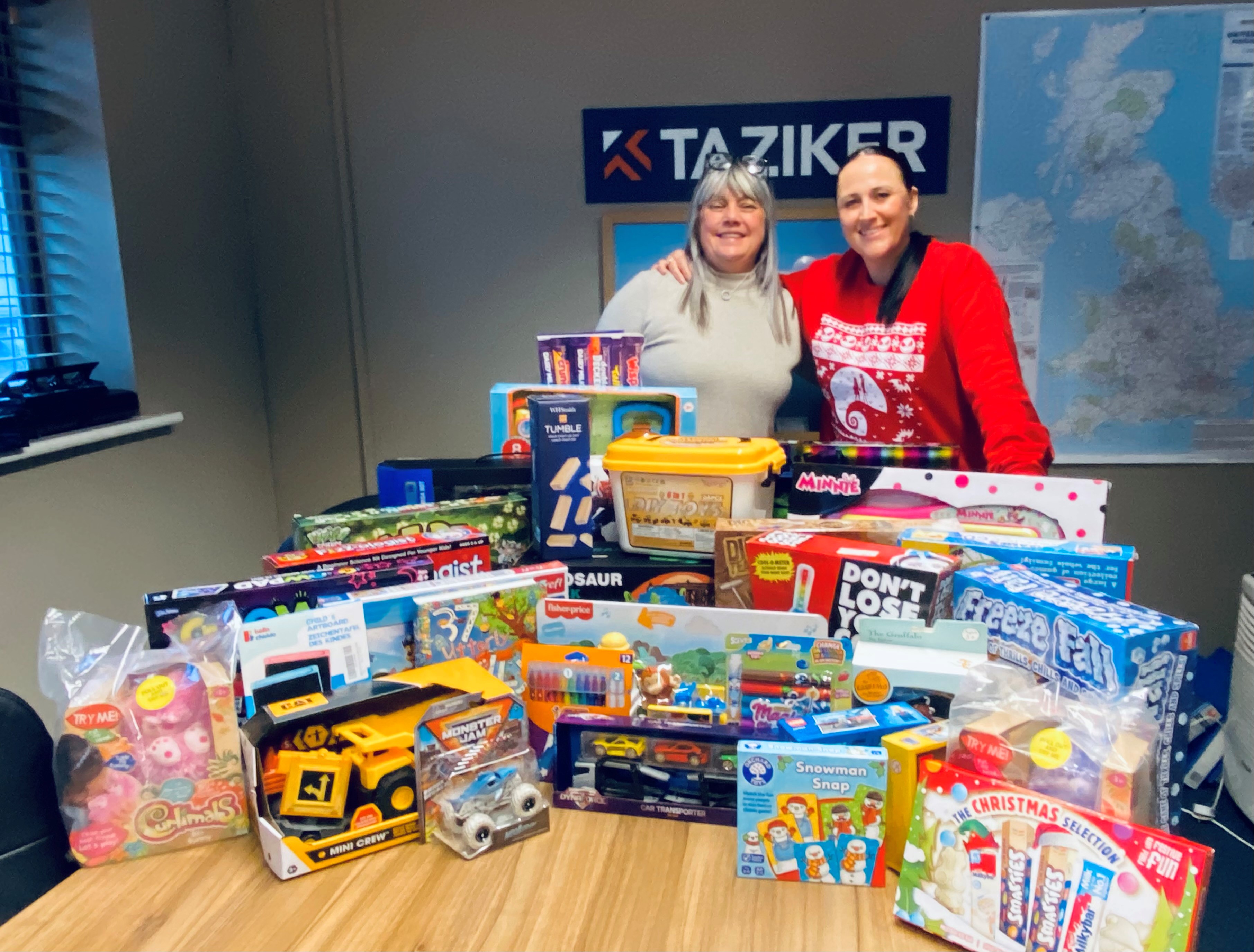 Taziker employees with Christmas presents in the Horwich office.