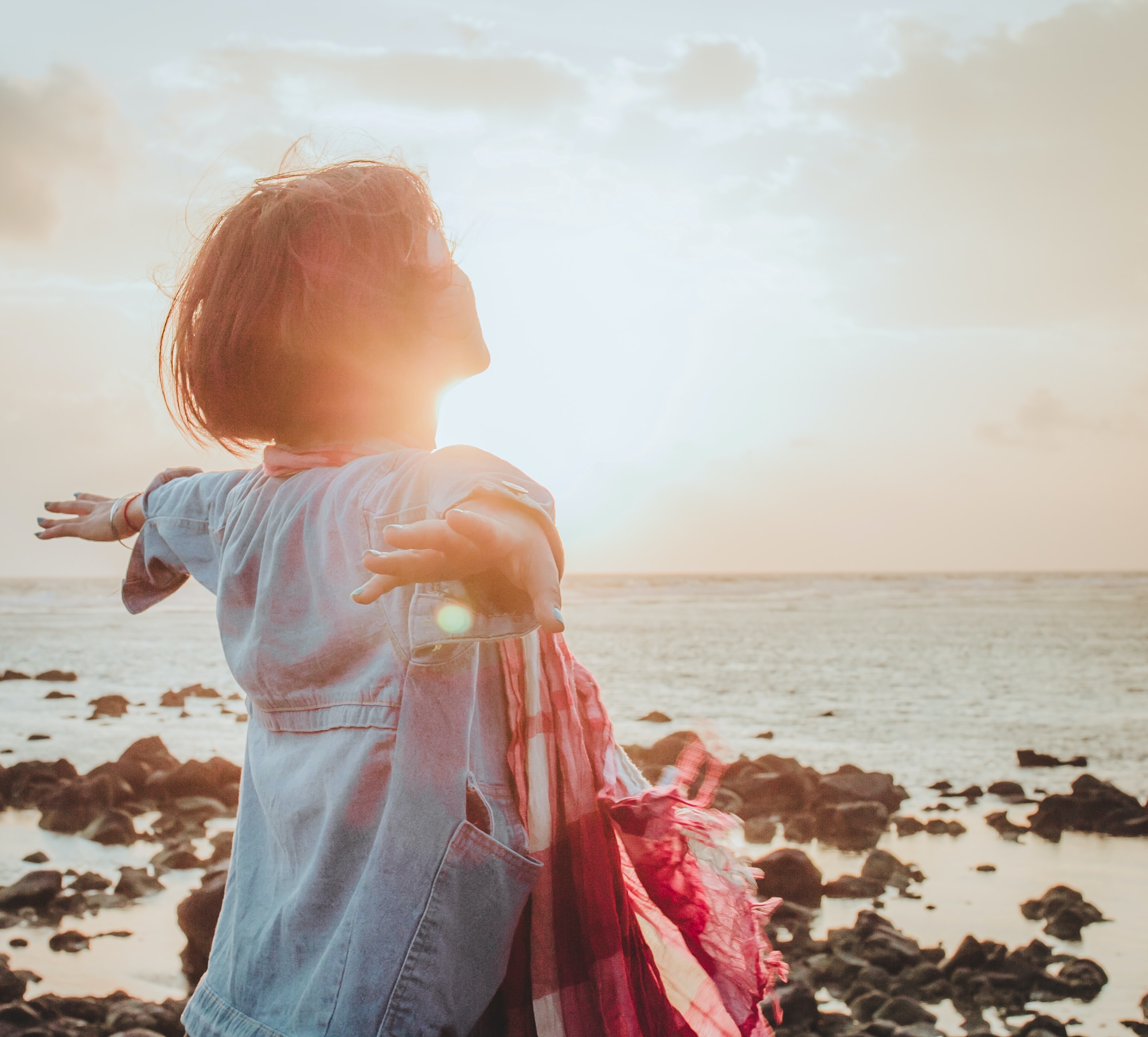 Girl in the sunlight on the beach.